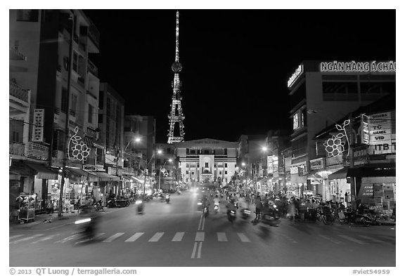 Main street and telecomunication tower at night. Tra Vinh, Vietnam (black and white)
