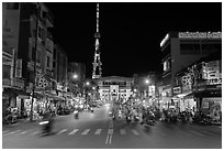 Main street and telecomunication tower at night. Tra Vinh, Vietnam ( black and white)