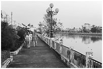 Elderly women strolling on riverfront. Tra Vinh, Vietnam (black and white)