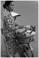 Woman vending food out of bicycle. Tra Vinh, Vietnam ( black and white)