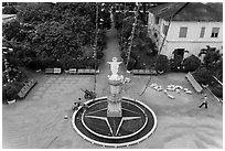 View of drying rice and statue from church tower. Tra Vinh, Vietnam (black and white)