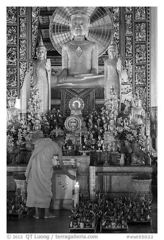 Monk lighting incense at  Ang Pagoda altar. Tra Vinh, Vietnam (black and white)