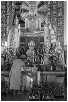 Monk lighting incense at  Ang Pagoda altar. Tra Vinh, Vietnam (black and white)