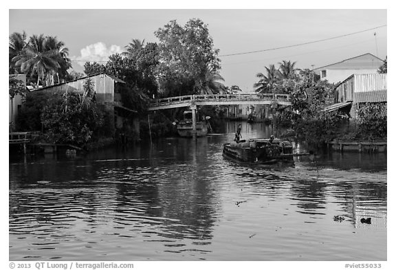 Barge and canal-side houses. Mekong Delta, Vietnam (black and white)