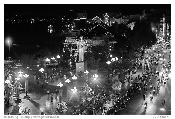 Mekong River, Ho Chi Minh statue, and street at night. Can Tho, Vietnam