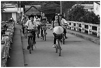 Children bike on way to school, Phung Diem. Can Tho, Vietnam (black and white)