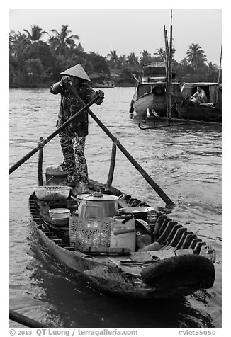 Woman paddles boat with pho noodles, Phung Diem. Can Tho, Vietnam (black and white)