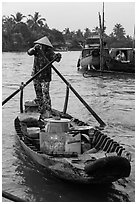 Woman paddles boat with pho noodles, Phung Diem. Can Tho, Vietnam (black and white)