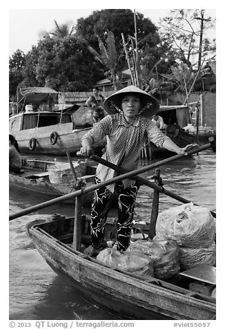 Woman using the x-shape paddles. Can Tho, Vietnam (black and white)