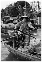 Woman using the x-shape paddles. Can Tho, Vietnam (black and white)