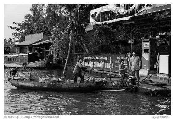 Women refilling boat tank. Can Tho, Vietnam