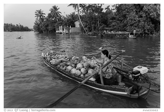 Woman pausing to eat noodles on the river. Can Tho, Vietnam (black and white)