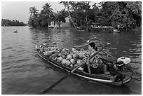 Woman pausing to eat noodles on the river. Can Tho, Vietnam ( black and white)