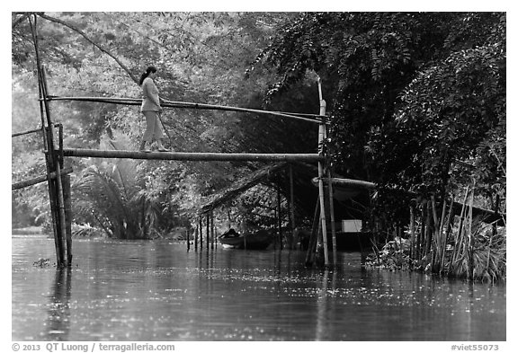 Woman crossing monkey bridge. Can Tho, Vietnam (black and white)