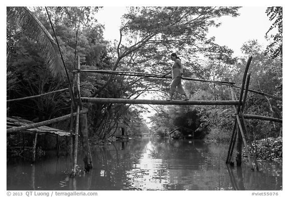 Woman traversing monkey bridge. Can Tho, Vietnam (black and white)