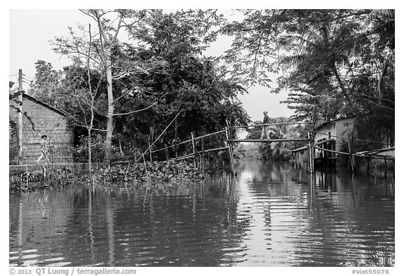 Riverside village and monkey bridge. Can Tho, Vietnam (black and white)