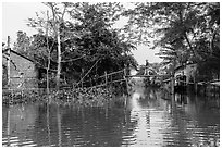 Riverside village and monkey bridge. Can Tho, Vietnam (black and white)