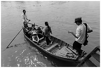 Schoolchildren stepping onto boat. Can Tho, Vietnam (black and white)