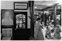 Women in prayer inside Quoc Tu pagoda. Ho Chi Minh City, Vietnam ( black and white)