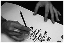 Feminine hand draws Lunar New Year greetings in fancy writing. Ho Chi Minh City, Vietnam ( black and white)