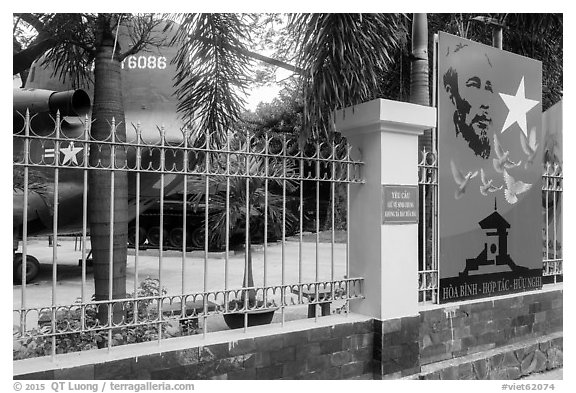 US Helicopter tail and fence with poster, War Remnants Museum, district 3. Ho Chi Minh City, Vietnam (black and white)