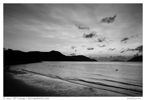 Con Son Beach with people in water before sunrise. Con Dao Islands, Vietnam (black and white)