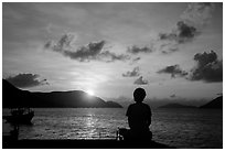 Sitting woman in silhouette and sunrise, Con Son. Con Dao Islands, Vietnam ( black and white)