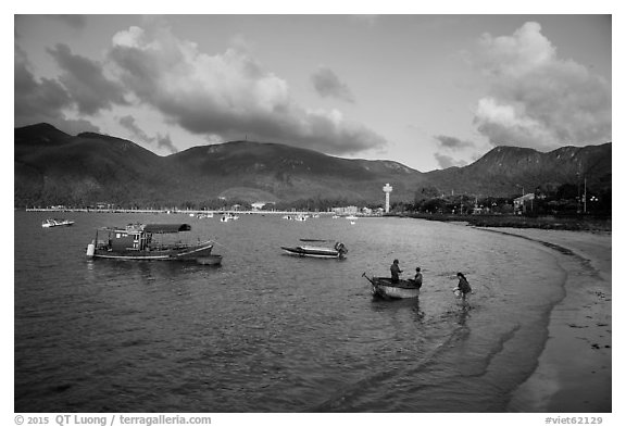 Woman collects catch from fishermen on coracle boat, Con Son. Con Dao Islands, Vietnam (black and white)