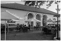 Patrons sitting on table in front of Con Son Cafe. Con Dao Islands, Vietnam ( black and white)