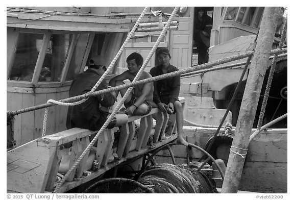 Fishermen relaxing on boats, Ben Dam. Con Dao Islands, Vietnam (black and white)