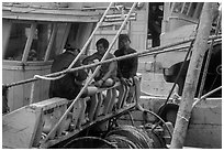 Fishermen relaxing on boats, Ben Dam. Con Dao Islands, Vietnam ( black and white)