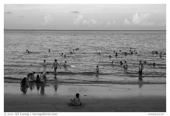 Beachgoers at sunset, Con Son. Con Dao Islands, Vietnam (black and white)