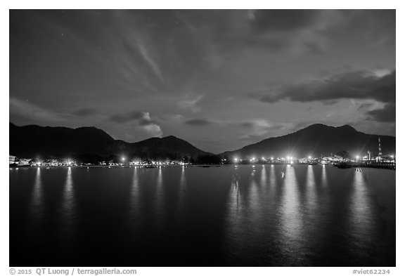 Lights of Con Son reflected in harbor at dawn. Con Dao Islands, Vietnam (black and white)