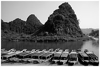 Tour boats and forest-covered limestone rocks, Son Trach. Vietnam ( black and white)