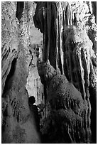 Tourist framed by cave formations, upper cave, Phong Nha Cave. Vietnam (black and white)