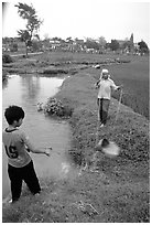 Field irrigation with a swinging bucket. Vietnam (black and white)