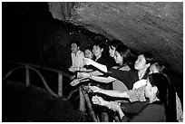 Women catch the water seeping from Tan Thanh Cave, said to have mirculous properties. Lang Son, Northest Vietnam ( black and white)