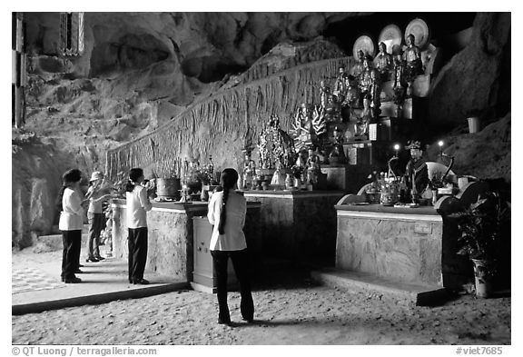 Women praying at the altar at the entrance of Tan Thanh Cave. Lang Son, Northest Vietnam (black and white)