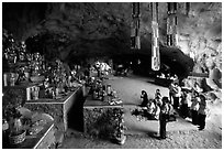 Group praying at the altar at the entrance of Tan Thanh Cave. Lang Son, Northest Vietnam (black and white)