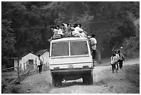 Passengers sitting on top of an overloaded bus. Northest Vietnam (black and white)