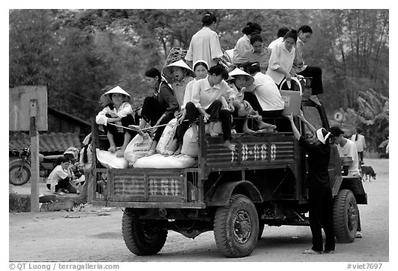 Riding in the back of an overloaded truck. Northest Vietnam (black and white)