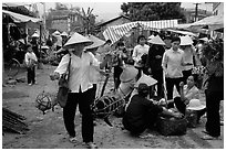 Woman carrying two live pigs, That Khe market. Northest Vietnam (black and white)