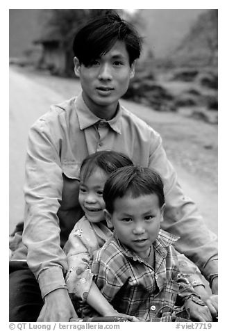 Young man carrying two kids on his bicycle. Northeast Vietnam (black and white)