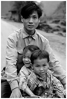 Young man carrying two kids on his bicycle. Northeast Vietnam (black and white)