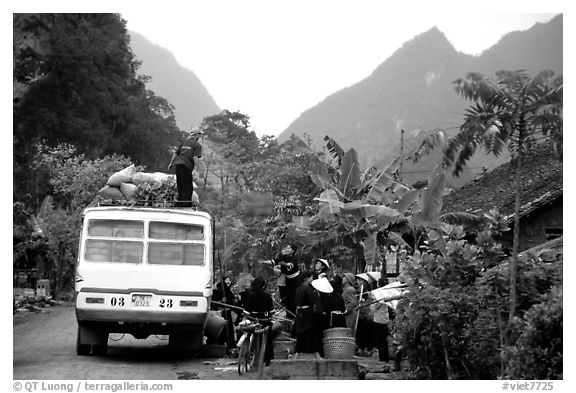Unloading of a bus in a mountain village. Northeast Vietnam (black and white)