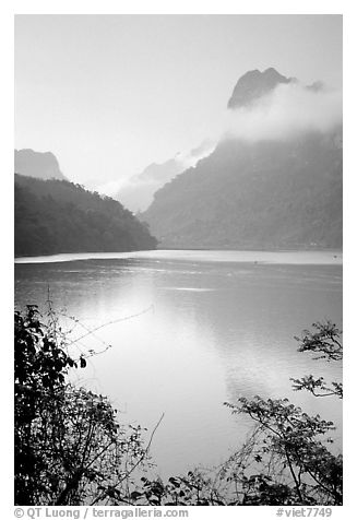 Morning mist on the tall cliffs surrounding Ba Be Lake. Northeast Vietnam (black and white)