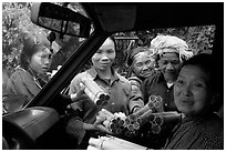 Peddlers offering sweet rice tubes for sale to traveler. Vietnam ( black and white)