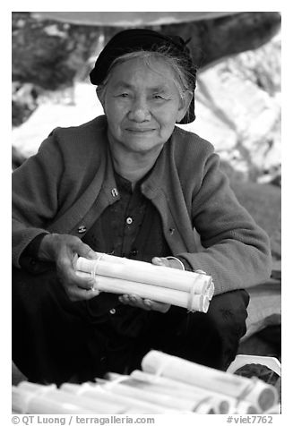 Woman selling sweet rice cooked in bamboo tubes. Vietnam (black and white)