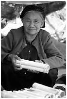 Woman selling sweet rice cooked in bamboo tubes. Vietnam (black and white)