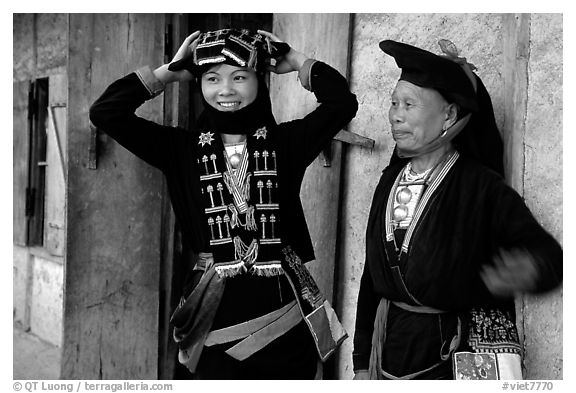 Two generations of tribewomen outside their house, near Mai Chau. Northwest Vietnam (black and white)
